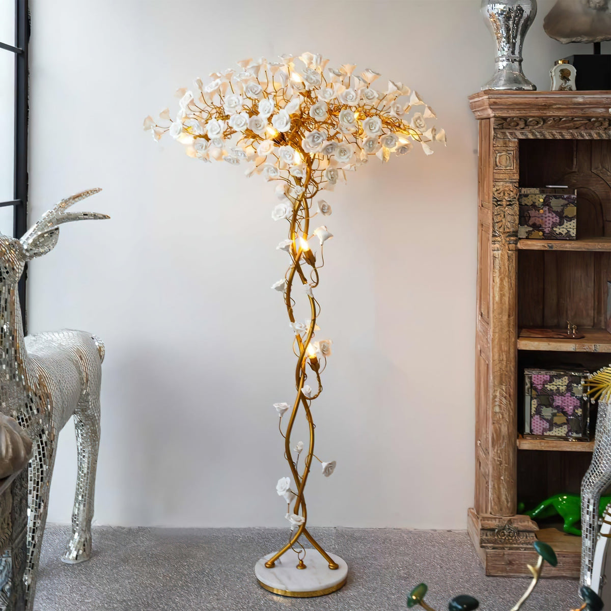 Tall decorative floor lamp with a branching metal structure and pale flower elements