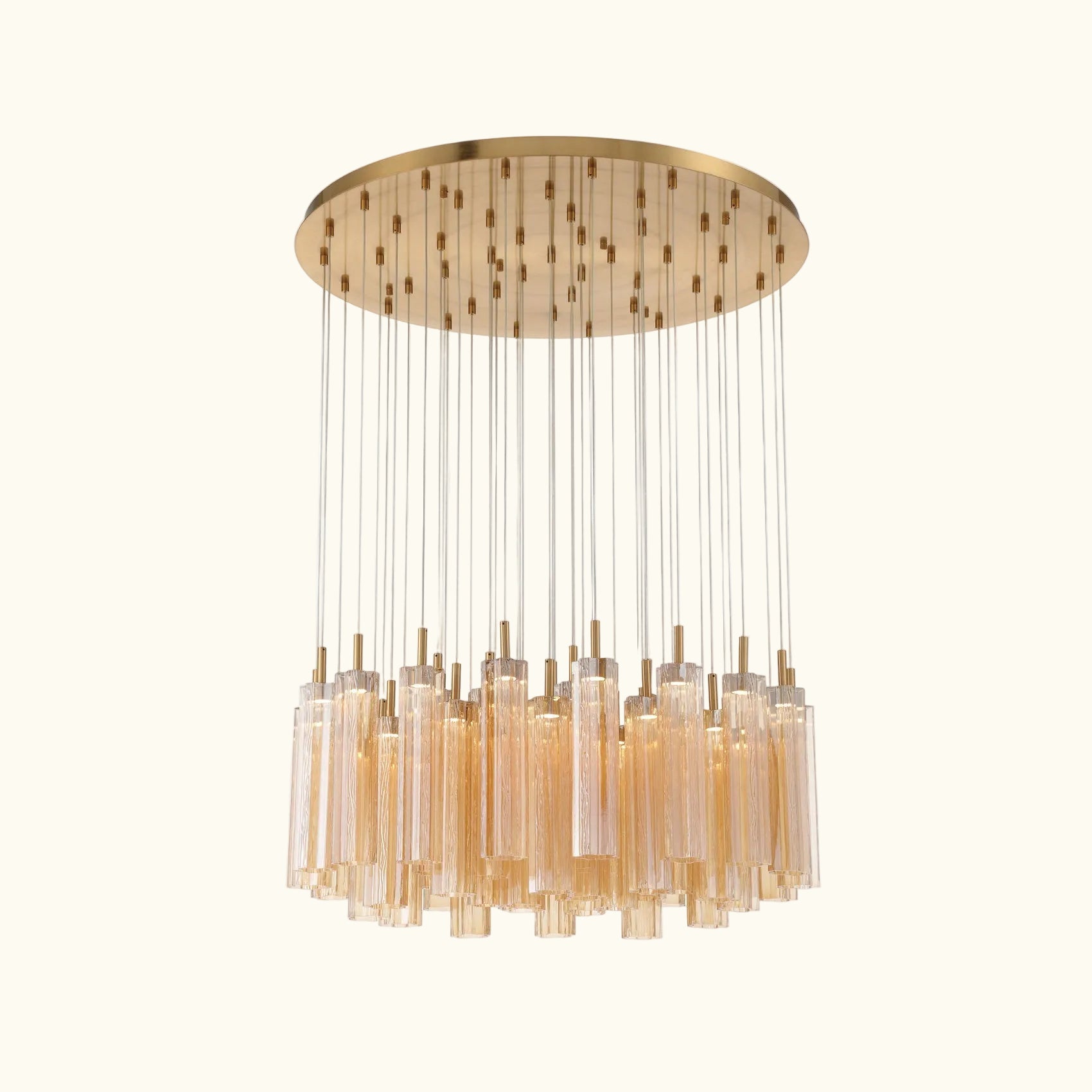 A modern multi-light chandelier with a brushed gold circular canopy, multiple thin suspension rods, and clear cylindrical glass shades, shown against a plain white background.