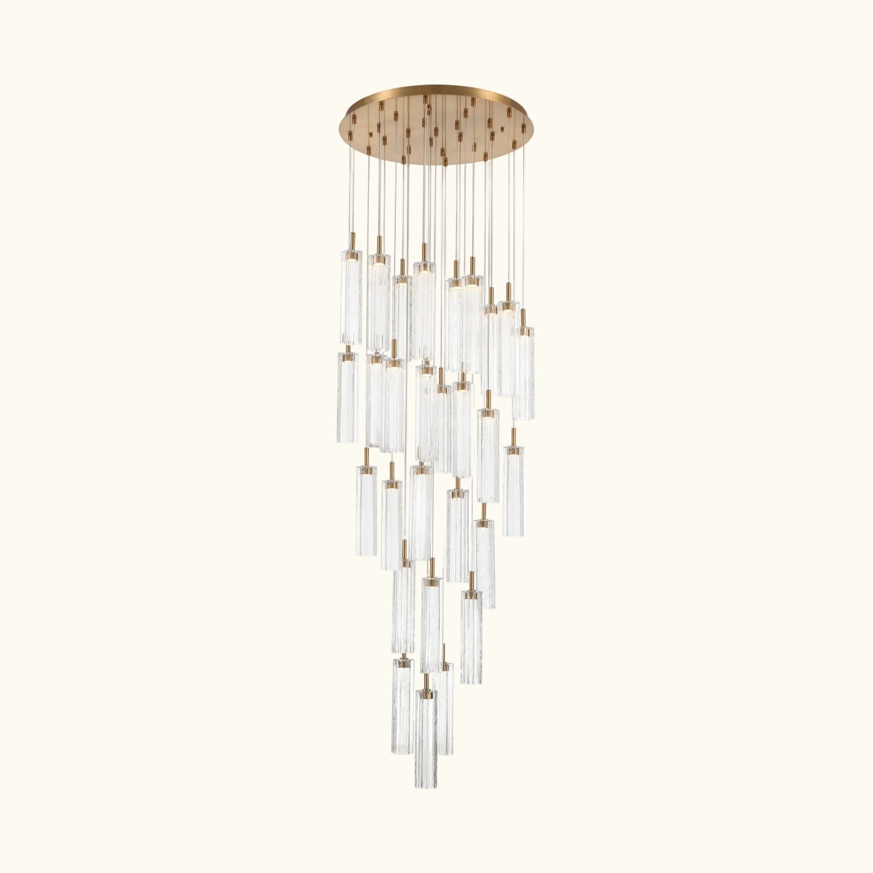 A modern multi-light linear chandelier with a brushed gold circular canopy and multiple clear glass cylindrical tubes of varying lengths, suspended against a plain white background.