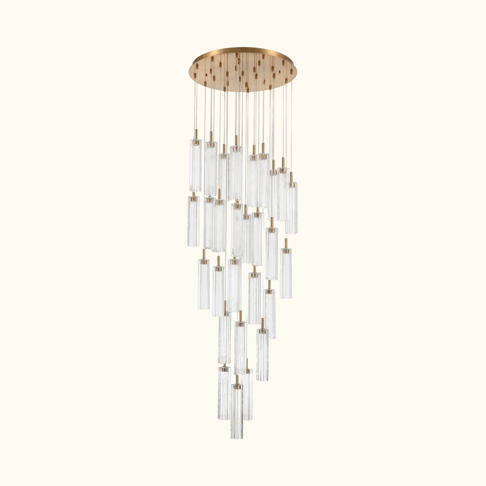 A modern multi-light linear chandelier with a brushed gold circular canopy and multiple clear glass cylinder shades of varying lengths, suspended against a plain white background.