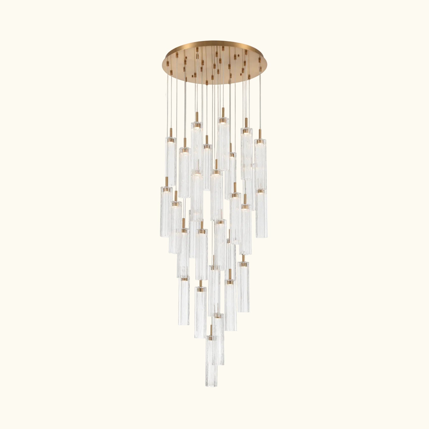 A modern multi-light chandelier with a brushed gold circular ceiling canopy and multiple clear glass cylinder tubes of varying lengths, suspended against a solid white background.
