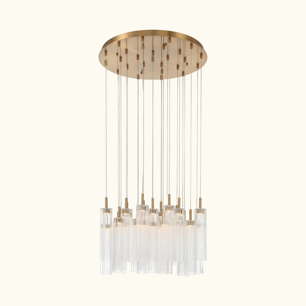 Gold pendant with a long cylindrical bar and circular top on a white background