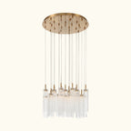 Gold pendant with a long cylindrical bar and circular top on a white background