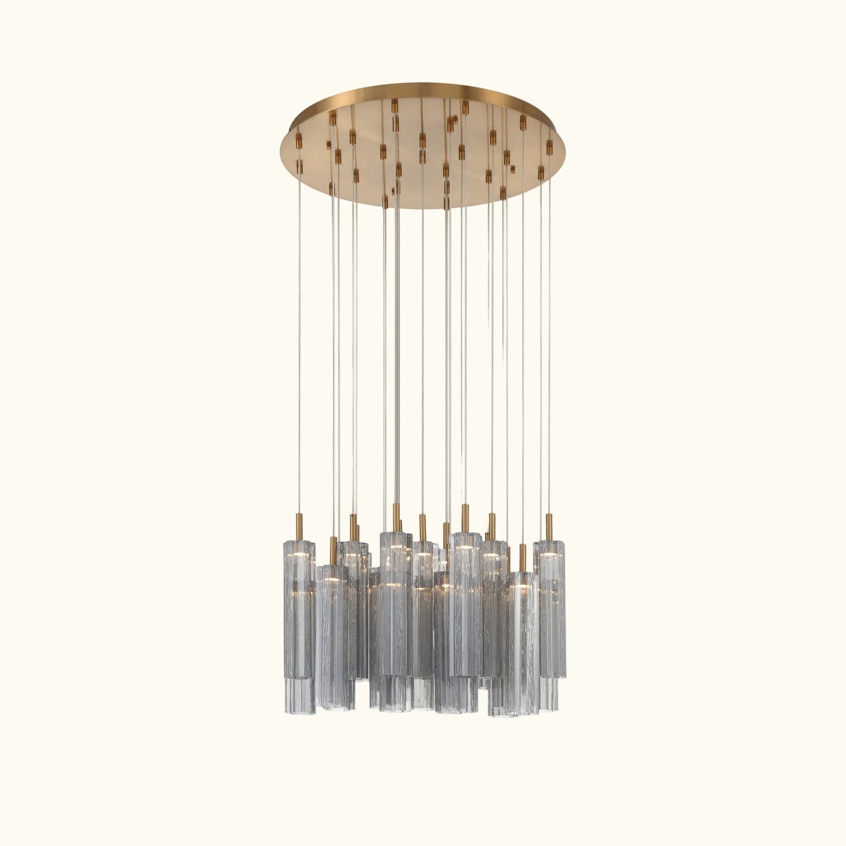 A modern multi-light linear chandelier with a brushed gold circular canopy and multiple clear glass cylinder shades suspended by thin rods, shown against a plain white background.