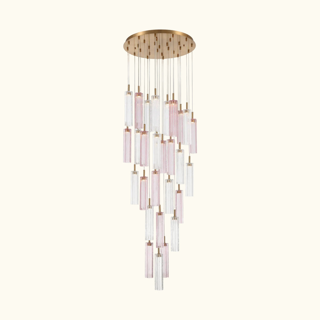 A modern multi-light linear chandelier with a brushed gold circular canopy and multiple clear glass tubes with soft pink tinted sections, suspended against a plain white background.