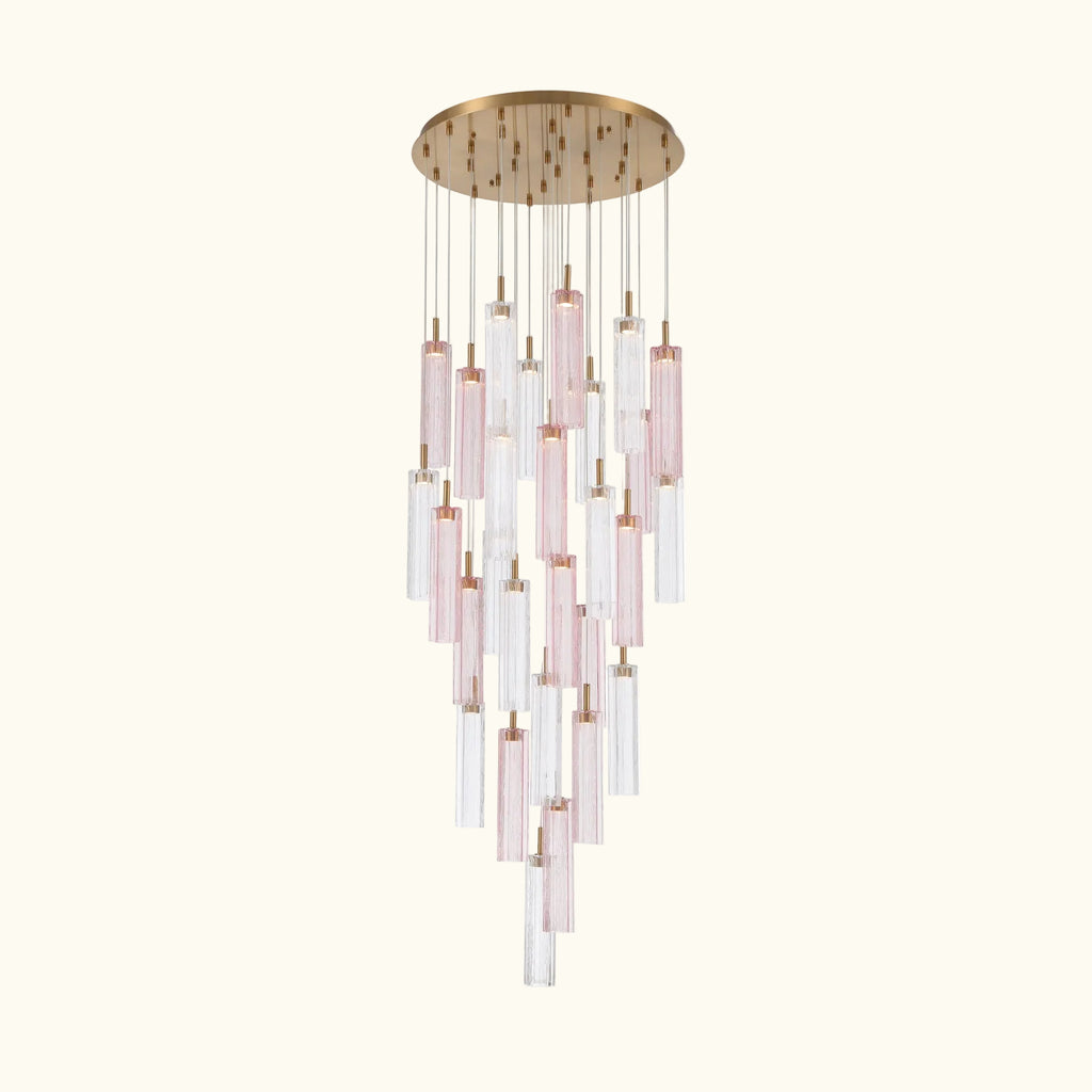 A modern multi-light linear chandelier featuring a round brushed gold ceiling canopy, clear glass tubes, and pink-tinted glass tubes suspended in a cascading, tiered arrangement.