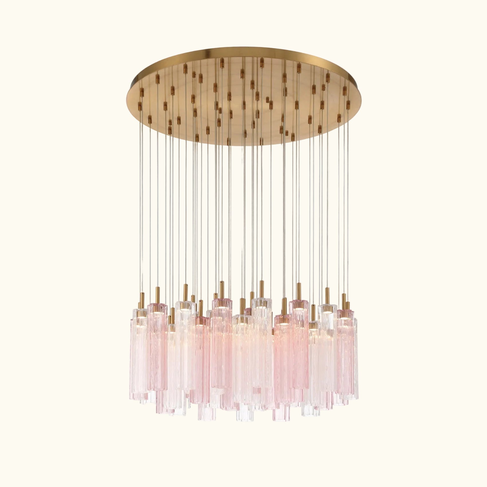 A modern multi-light chandelier pendant fixture with a circular brushed brass canopy, clear glass rods, and multiple pink-tinted glass cylinder drops, shown against a solid white background.
