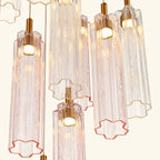 Chandelier with transparent pink and gold glass shades on a white background