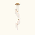 Modern pendant light with cylindrical glass shades on a white background