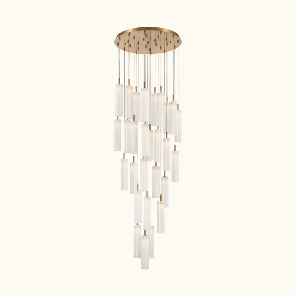 A modern multi-light chandelier with a brushed gold circular canopy and multiple clear cylindrical glass shades of varying lengths, suspended against a plain white background.
