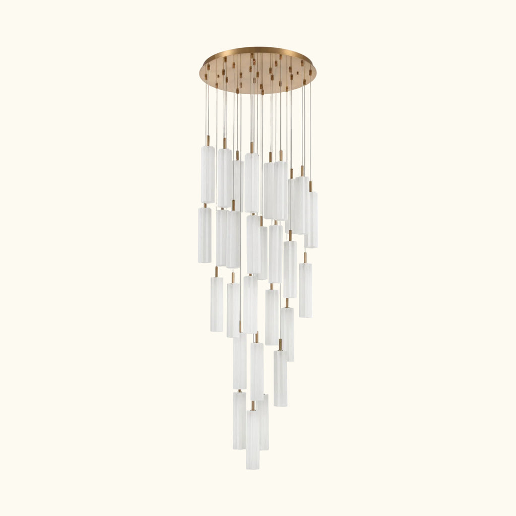 A modern multi-light linear chandelier with a brushed gold circular canopy and multiple clear cylindrical glass shades of varying lengths, suspended against a plain white background.