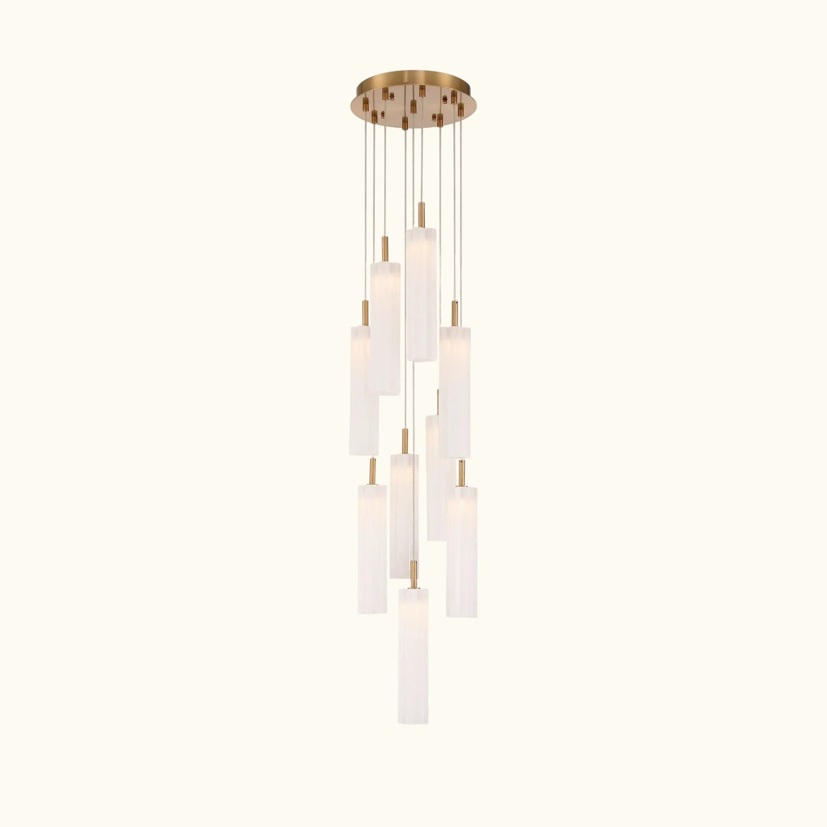 A modern multi-light linear chandelier with a brushed gold ceiling canopy and multiple cylindrical frosted glass shades of varying lengths, suspended against a solid white background.