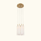 A modern multi-light pendant ceiling fixture with a brushed gold circular canopy, four slim suspension rods, and four cylindrical frosted glass shades, shown against a plain white background.