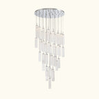 A modern multi-light chandelier with a circular silver ceiling canopy and multiple clear glass cylinder shades of varying lengths, suspended against a plain white background.