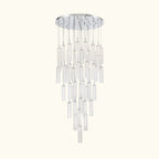 A modern multi-light chandelier with a circular silver canopy, clear glass cylinder shades, and multiple hanging clear glass rods of varying lengths, shown against a plain white background.