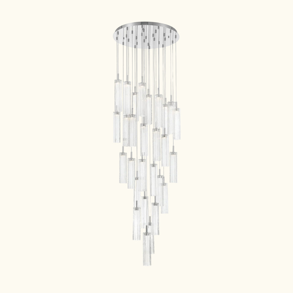 A modern multi-light linear chandelier with clear glass cylindrical tubes and polished silver metal accents, suspended from a circular silver ceiling canopy.