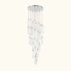A modern multi-light linear chandelier with clear glass cylindrical tubes and polished silver metal accents, suspended from a circular silver ceiling canopy.