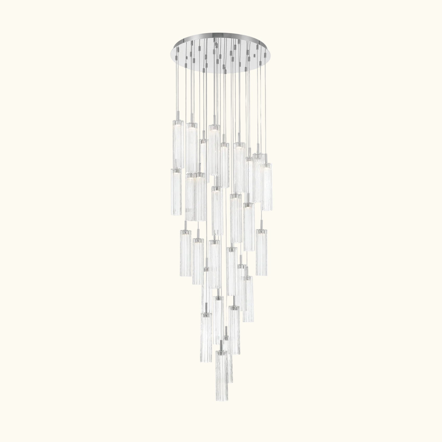 A modern multi-light linear chandelier with clear glass cylindrical tubes and polished silver metal accents, suspended from a circular silver ceiling canopy.