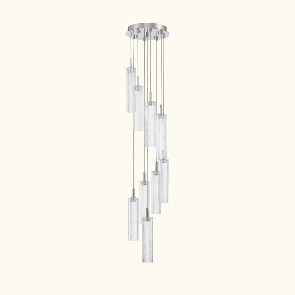 A modern multi-light linear chandelier with clear cylindrical glass shades and a polished silver-tone metal canopy and cords, shown against a plain white background.