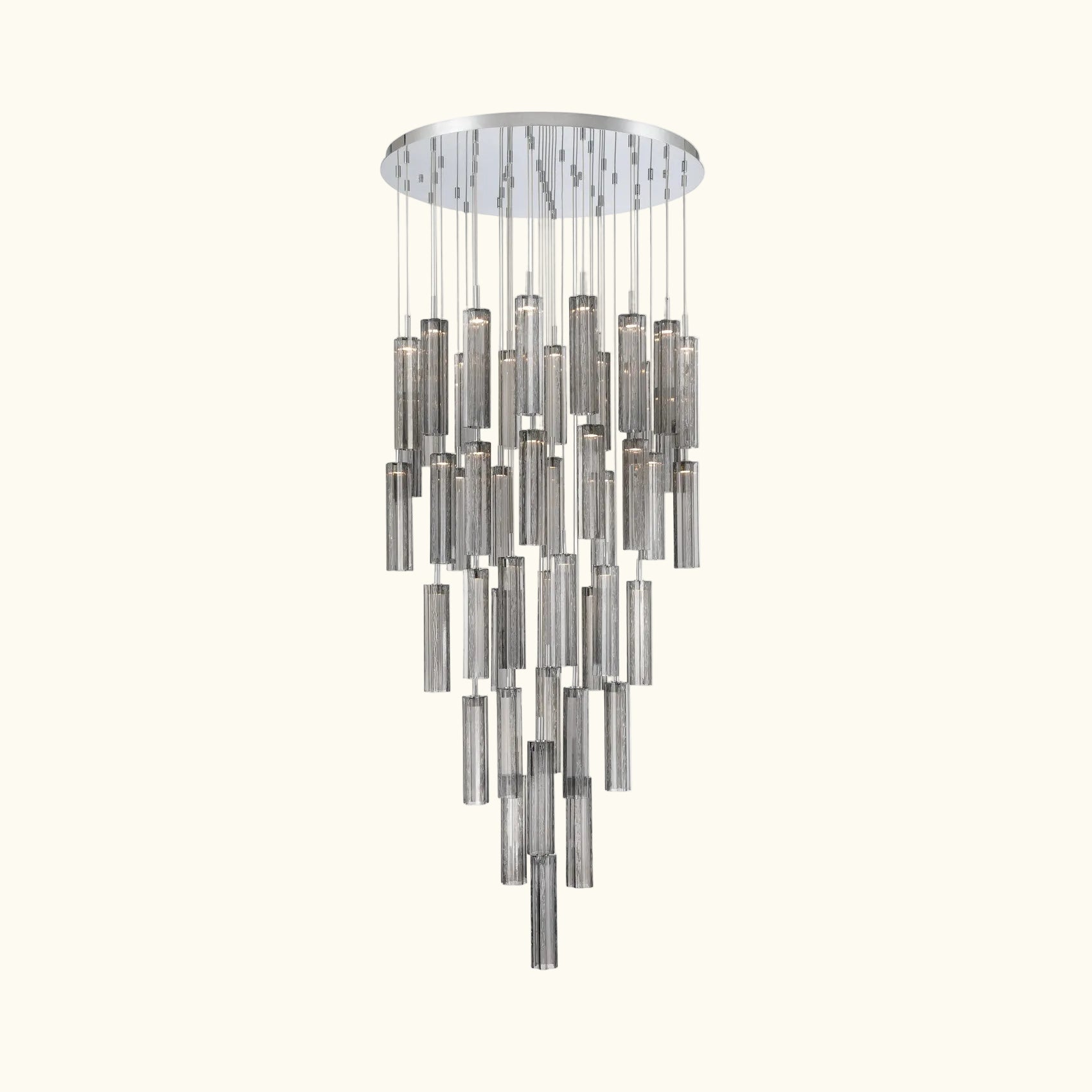 A modern multi-light chandelier with a circular silver canopy and multiple tiers of hanging cylindrical glass shades in brushed silver and smoked gray, shown against a plain white background.