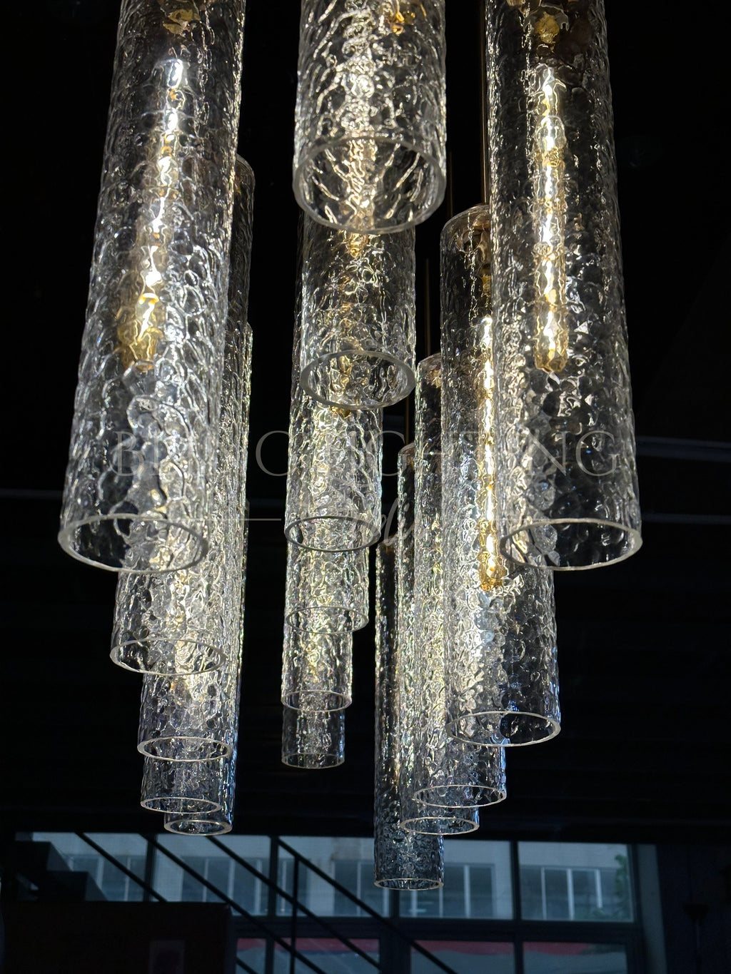 Colleena hammered glass chandelier viewed from below, showing open cylinder shades