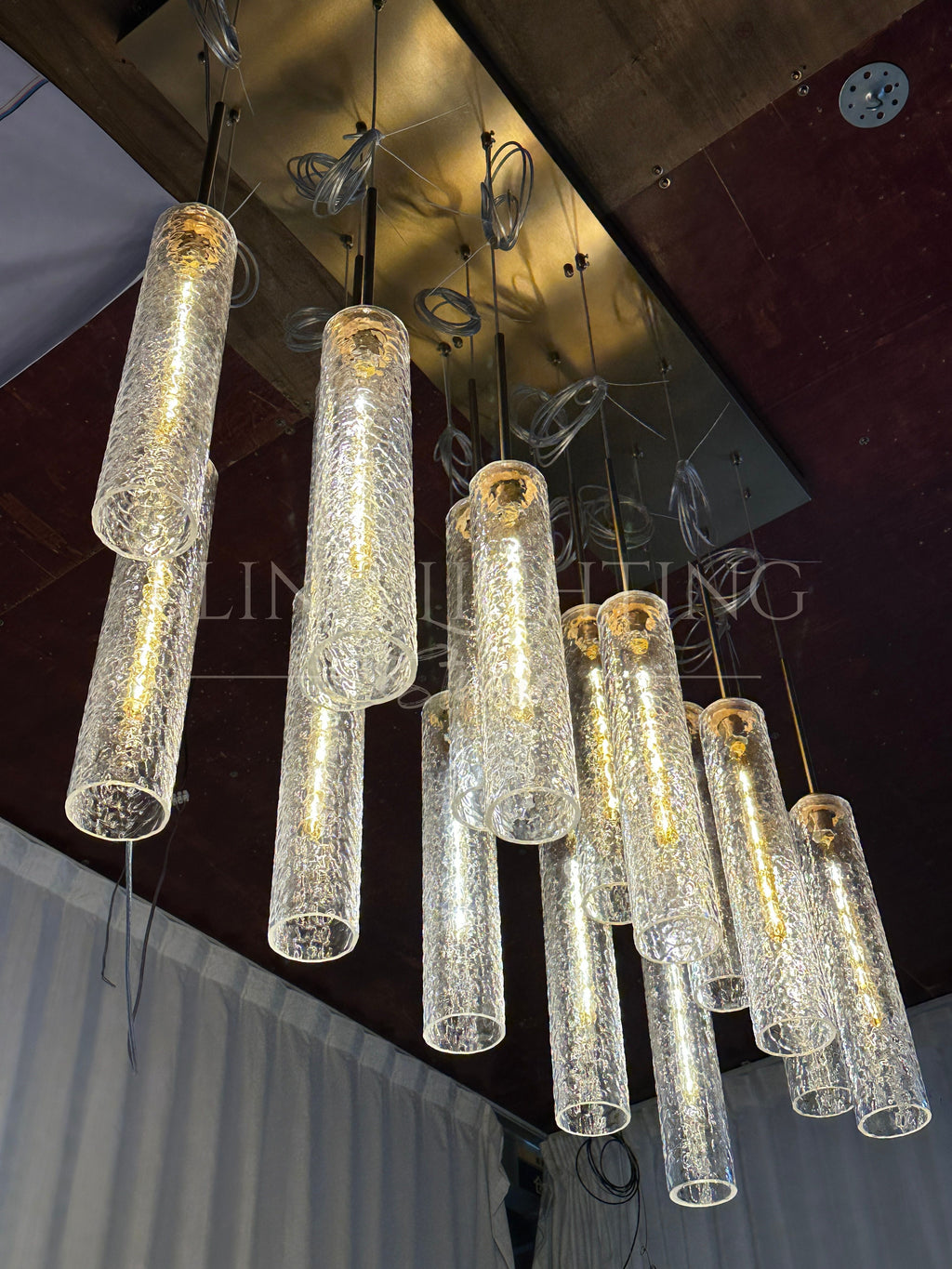 Low-angle view of the Colleena hammered glass chandelier and rectangular canopy