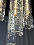 Colleena chandelier detail showing the open ends and hammered texture of clear glass shades