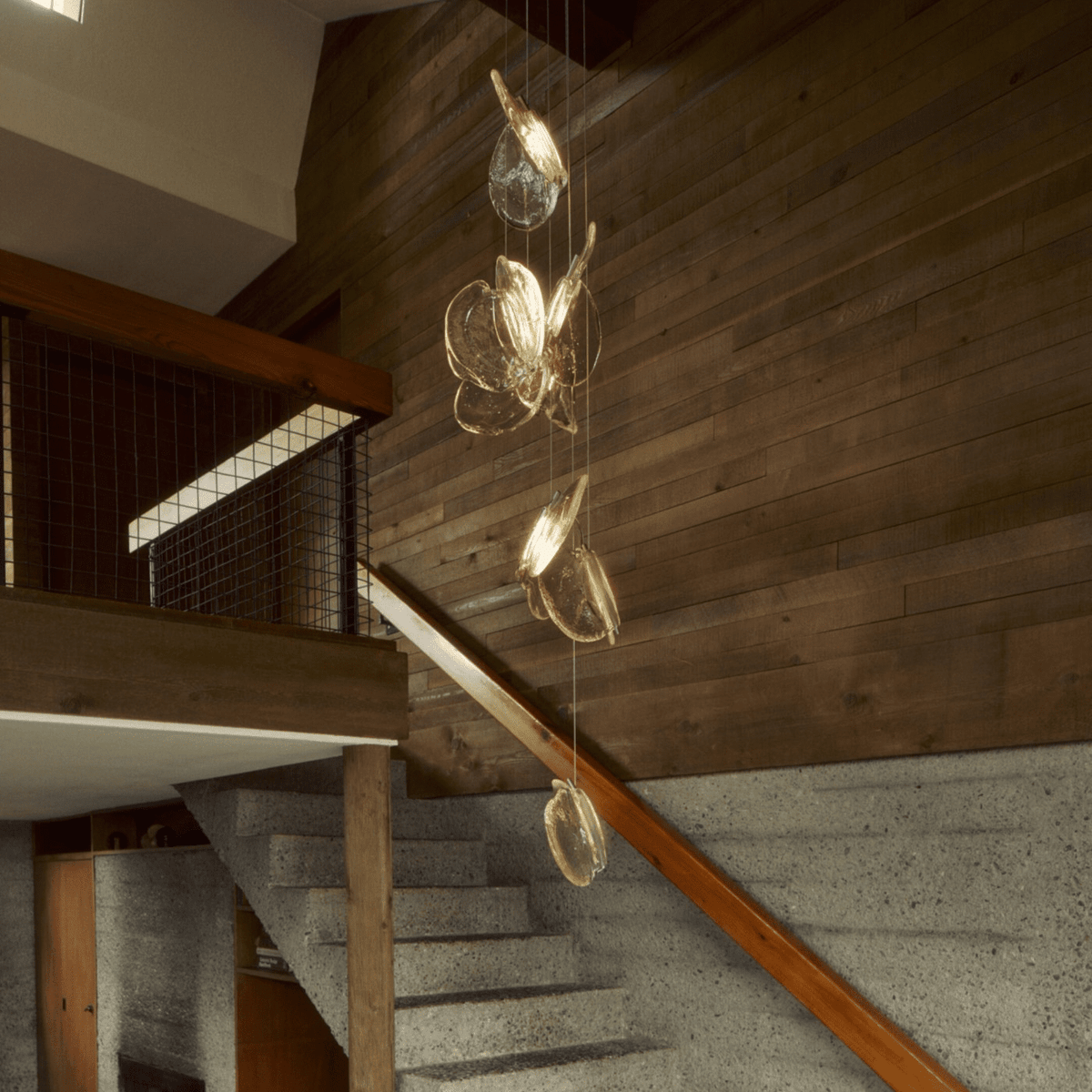 Luminous Glass Petals Pendant Lamp chandelier in a tall interior