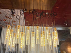 Colleena linear chandelier with illuminated hammered glass cylinder pendants at staggered heights