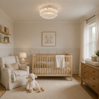A beautifully styled nursery featuring a light wood crib, a cream armchair, a plush white sheep toy, and a crystal chandelier overhead.