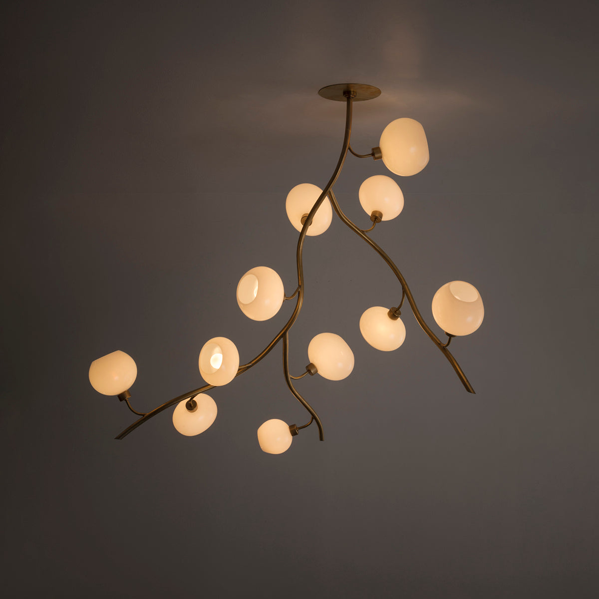 Branch Chandelier for Staircases with Brass Arms and Glass Globes 50″H chandelier in a tall interior