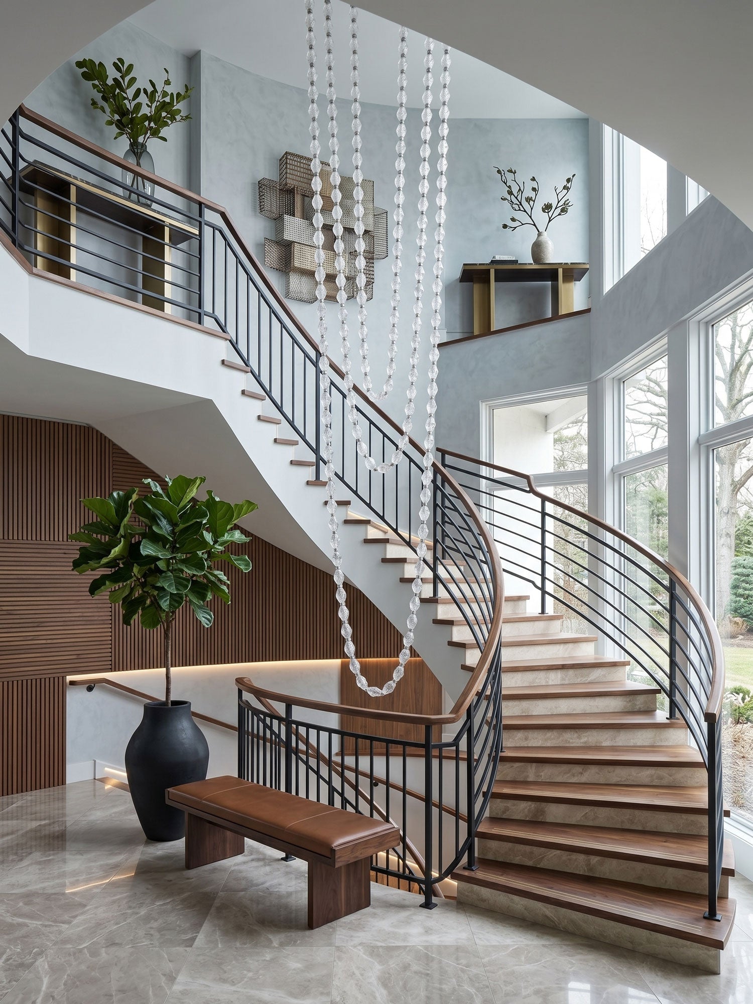 Riviere Glass Chain Chandelier installed in a double-height staircase