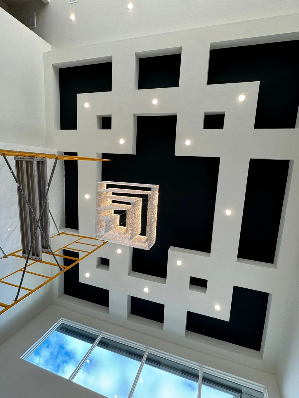 Aisha Tassel Chandelier installed in a high ceiling interior with aluminum chain tassels