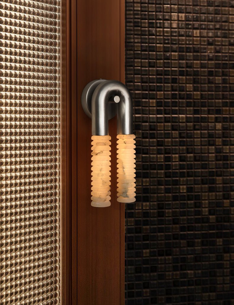 Arc Ridge Alabaster Wall Sconce — product setting and fixture profile, two ribbed stone columns joined by a curved metal arch (view 2)