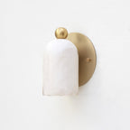 Bombelles Alabaster Wall Lamp — product setting and fixture profile, a domed stone shade against a round metal backplate (view 2)