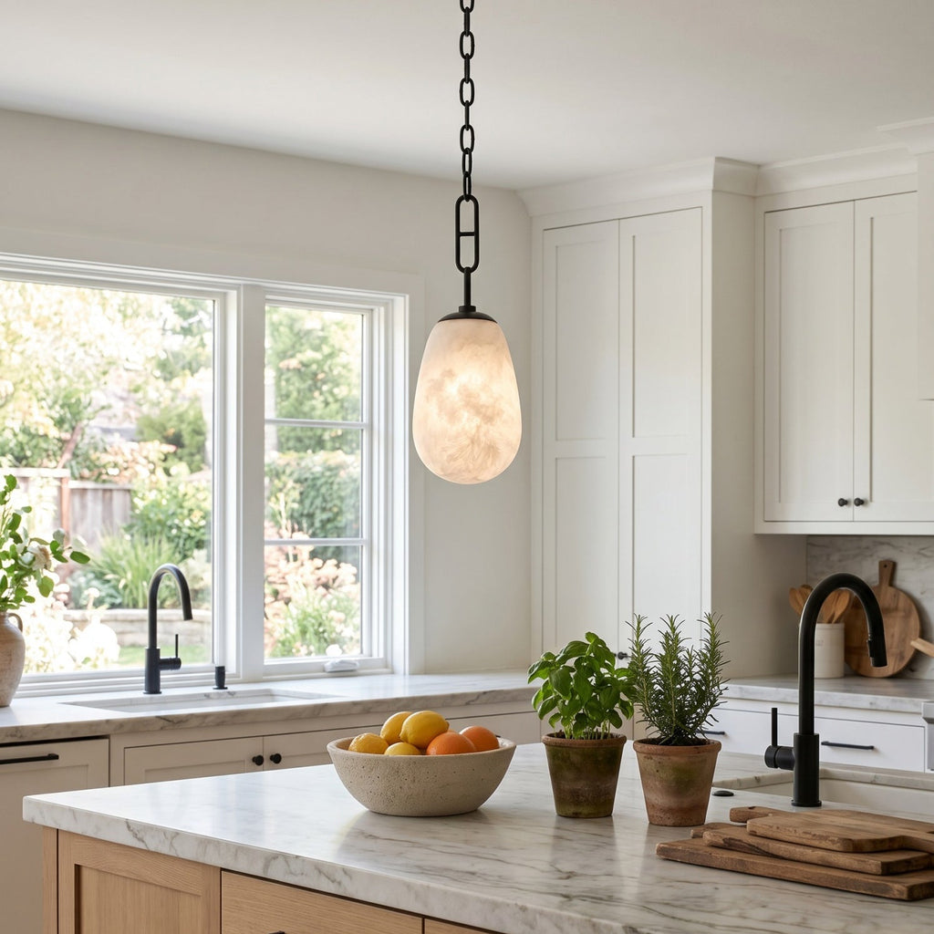 Bruckner Alabaster Pendant Lamp — product setting and fixture profile, a teardrop-shaped stone shade on a brass link chain (view 2)