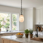 Bruckner Alabaster Pendant Lamp — product setting and fixture profile, a teardrop-shaped stone shade on a brass link chain (view 2)