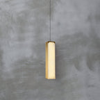 Chaos Alabaster Pendant Light — product setting and fixture profile, a slender stone cylinder suspended on fine cables (view 2)