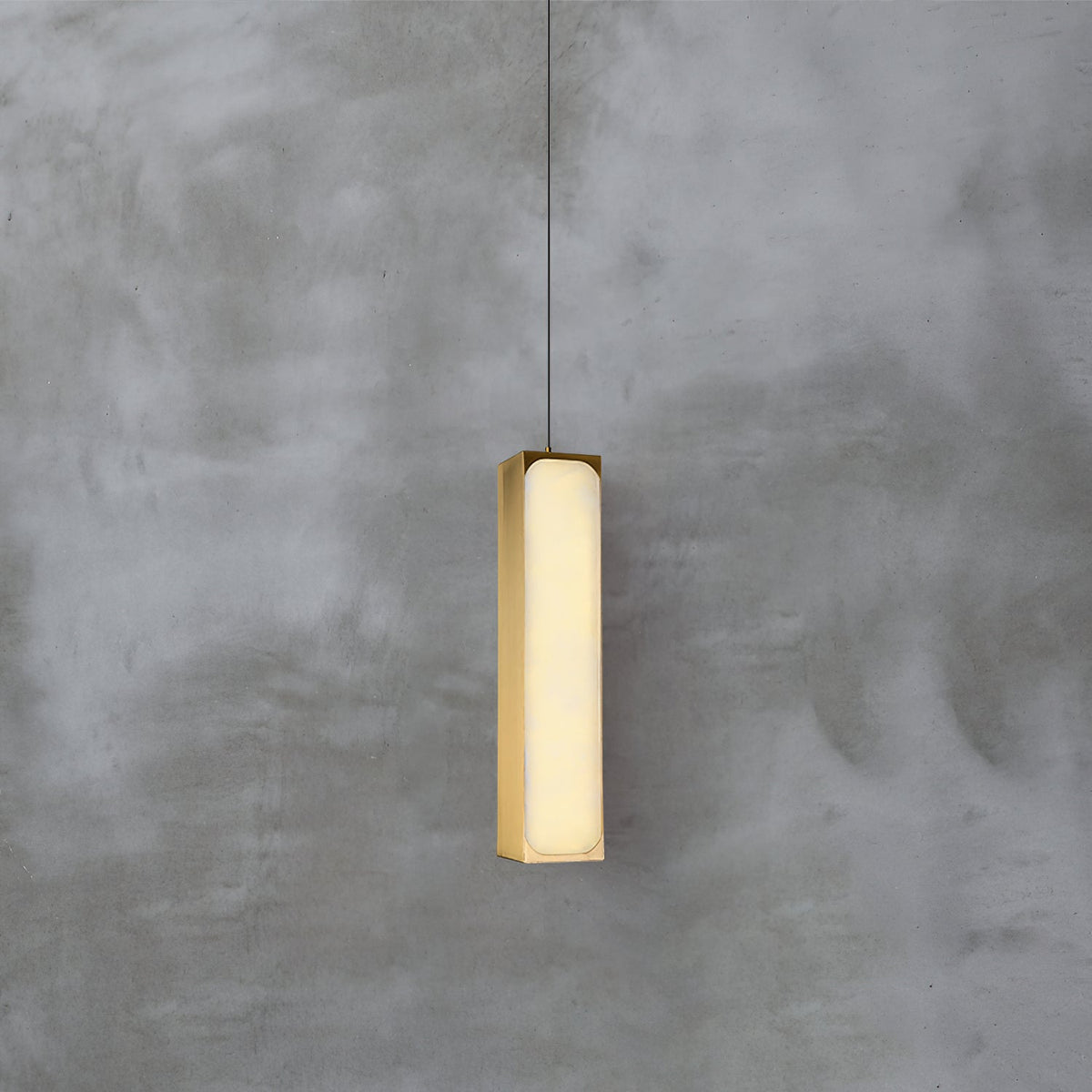 Chaos Alabaster Pendant Light — product setting and fixture profile, a slender stone cylinder suspended on fine cables (view 2)