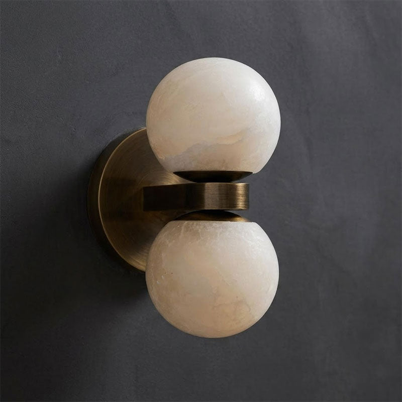 Dual Globe Alabaster Wall Lamp — product setting and fixture profile, two rounded stone shades on a brass wall mount (view 2)