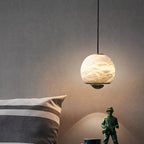 Ferox Alabaster Pendant Light — product setting and fixture profile, a stone body with a lens-like lower diffuser (view 2)