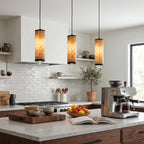 Three Fina cylindrical pendants installed above a kitchen island