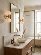 Garrison Alabaster Wall Sconce — product setting and fixture profile, a stone shade accented by warm antique brass fittings (view 2)