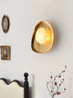Haloform Aurea Alabaster Wall Lamp — product setting and fixture profile, a stone center surrounded by an irregular brass frame (view 2)