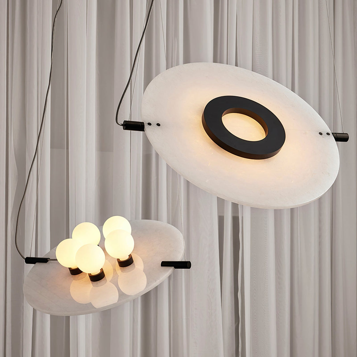 Magma Alabaster Pendant Lamp — product setting and fixture profile, stone discs within a dark metal frame (view 2)