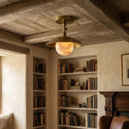 Marie Petite Hammer Pattern Flush Mount — product setting and fixture profile, a stone globe beneath a textured brass dome (view 2)