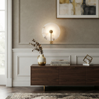Medallion Alabaster Wall Sconce — additional product view, a round stone disc crossed by an angular metal arm (view 3)