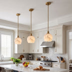 Mian Alabaster Pendant Lamp — product setting and fixture profile, a lotus-like stone shade below a slim brass rod (view 2)