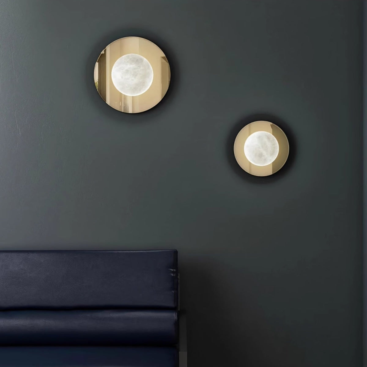 Ophela Alabaster Sconce — product setting and fixture profile, a carved stone shade on a brass wall backplate (view 2)