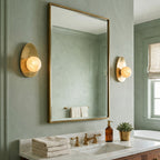 Orba Alabaster Wall Sconce — product setting and fixture profile, a round stone shade on a brass wall mount (view 2)